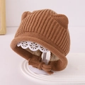 Detail of baby bear ear knit hat with warm cotton lining and decorative bow straps - 1-3 Years / Coffee