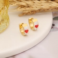 Golden heart earrings with red clay and white rhinestones on white tray - Red