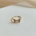 Golden bow-shaped open ring featuring a teardrop diamond and pavé crystal accents - Gold Bow Teardrop Zircon Ring (J2967)