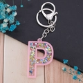 Pink glitter letter P keychain featuring colorful star sequins and silver lobster clasp - Letter P