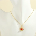 Detail of a Christmas bell pendant necklace with red enamel and micro-inlaid colorful zircons - Bow Combination