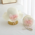 Detail of cream straw hat and matching round bag with pink bow and bunny charm - Cream