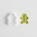 Gingerbread man cookie cutter with matching green dough cutout on a white background - E0852-Gingerbread Man