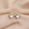 Elegant gold bee stud earrings with white pearls and sparkling zircons on silk background - Gold Bee Pearl