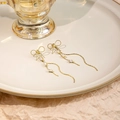 Elegant gold bow earrings with square zircon and long wavy tassels on white plate - E2361 Gold Bow Long Tassel