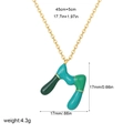 Golden necklace with letter M pendant featuring green and blue enamel drips - M