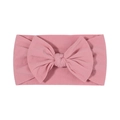 Soft pink nylon baby headband with a large fabric bow on a clean white background - Pink