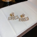 Golden star DREJ letter stud earrings with white zircons in a jewelry box - Star Letter Rhinestone Style (113#) with Silver Earring Post / Gold