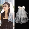Short white double-layered bridal veil featuring a satin bow and wavy mesh edge - Double Layer Wavy Edge Bow