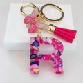 Close-up of resin letter R keychain with rose red tassel and golden butterfly charm - Rose Red Butterfly Tassel Clip / Letter R