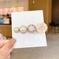 Elegant pearl hair clip with resin sea star charm and gold metallic base detail - Planet 85 Is Golden.