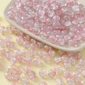 Detail of 10mm glass beads with pink ice-crackle texture on a white decorative dish - 10mm / Light Pink
