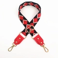 Detail of red and black jacquard woven bag strap with red leather ends and gold metal hooks - No.9 Black Red Jacquard + Red Leather