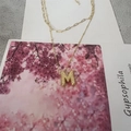 Double-layered golden necklace with bead chain, paperclip chain, and textured M-letter pendant - M
