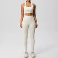 Detail of high-waisted yoga leggings with side pocket and racerback sports bra in cream white - Light Ivory
