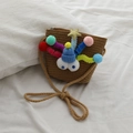 Mini brown woven straw crossbody bag for girls with cute cartoon monster face design - Coffee