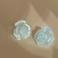 Detailed view of light blue resin rose stud earrings with a 3D layered petal design - Silver Earring Post Style / Blue