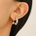 Close-up of polished silver horseshoe hoop earring with ball ends on male model - Smooth Horseshoe Hoop Earring (6758)