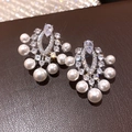 Primo piano di orecchini vintage in argento con strass e perle eleganti. - Stile Petalo di Perla Con Diamanti (36#)