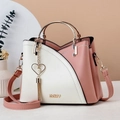 Pink and white contrast leather handbag with round golden handles and a heart charm - Pink & White Patchwork