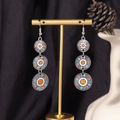 Detail of bohemian silver drop earrings with colorful enamel on a black backdrop - S4290-3 Orange Enamel Triple Ring Earrings