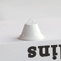 Close-up of a glossy white lacquered metal bell ornament with top hanging loop - 4.5CM / White