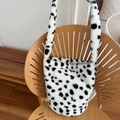 Faux fur tote bag featuring a black and white cow print with soft plush texture - Black and White Plush Bucket Bag (Magnetic Closure)