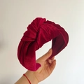 Detail of burgundy velvet knotted headband featuring a thick pleated texture - Red