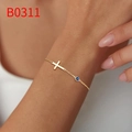 Gold-plated dainty cross bracelet featuring a small round blue gemstone on wrist - Dark Blue (B0311)