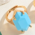 Macro shot of gold ring with large light blue hexagon stone and zircon accents - Turquoise Blue Hexagon