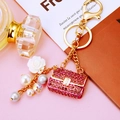 Detail of pink rhinestone handbag keychain with pearls and white rose charm - Purple Pearl Handbag