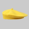 Close-up of a yellow wool beret showing soft fabric texture and the top stem detail - One Size / Yellow