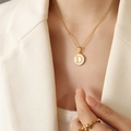 Minimalist gold chain necklace with letter D pendant on white mother-of-pearl disc - Letter D (RP014)