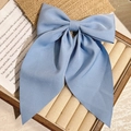 Light blue large bow hair clip with long ribbons on a decorative display stand - Blue With Ribbon