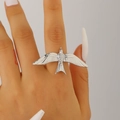 Detailed macro view of a silver-toned flying bird ring on a model's finger - Silver Ring