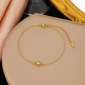 Polished gold beaded stainless steel chain anklet displayed on champagne silk background - Gold Stainless Steel Bead Bracelet (SLE2063)