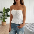 Detailed close-up of white strapless tube top with ruffle hem and sweetheart neckline - S / White