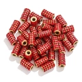 Macro detail of golden cylindrical beads with micro-paved red crystals for DIY jewelry - Red