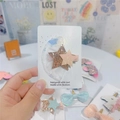 Close-up of glitter star hair clip with pink mesh detail on a white display card - Light Yellow Star