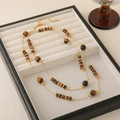 Handmade tiger eye beaded necklace with gold chain in a white jewelry display box - High Quality Tiger Eye Sweater Chain