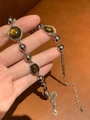 Silver bead chain necklace with amber crystal stone charm held in hand - Tiger Eye Beaded Necklace