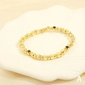 Detail of gold square beaded elastic bracelet on a white shell ceramic tray - BR1683-A/Gold Square Beads
