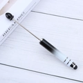 Black and white gradient beaded stylus pen with metal rod on white wooden background - Gradient Black