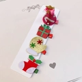 Detail of Christmas hair clips featuring sequined hat, gift box, glove, and stocking motifs - 4-Piece Sequin Christmas Hair Clip Collection