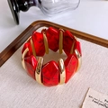 Detailed view of red marble resin blocks and gold metal segments on wide cuff bracelet - Gold Red Marble Pattern Resin