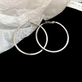 Detailed view of silver twisted geometric hoop earrings on black and white surface - 33# Geometric Simple Polished Silver Hoop - 45mm Diameter