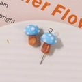 Macro shot of blue glass mushroom charms with white polka dots for DIY jewelry making - No.19 (Blue Cap White Dot Brown Stem)