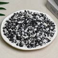 Natural black and white obsidian stone chips displayed in a white decorative ceramic dish - Black And White Zebra (5-7mm) 100g