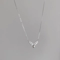 Detailed view of S925 silver V-shaped pendant with cubic zirconia and a white pearl - Total length 45cm adjustable / White Gold