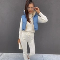 Close-up of blue quilted vest featuring stand collar and adjustable drawstring hem detail - S / Blue & Apricot